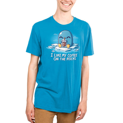 Premium Cotton T-shirt - Person wearing a cobalt blue apparel with a cartoon penguin holding iced coffee and the text "I like my coffee on the rocks," showcasing the super soft ringspun cotton fabric of the I Like My Coffee on the Rocks by monsterdigital.