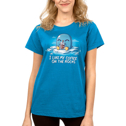 Premium Cotton T-shirt - A person wearing a cobalt blue apparel featuring a cartoon penguin holding iced coffee and the text "I like my coffee on the rocks." The I Like My Coffee on the Rocks apparel by monsterdigital is made from super soft ringspun cotton for ultimate comfort.