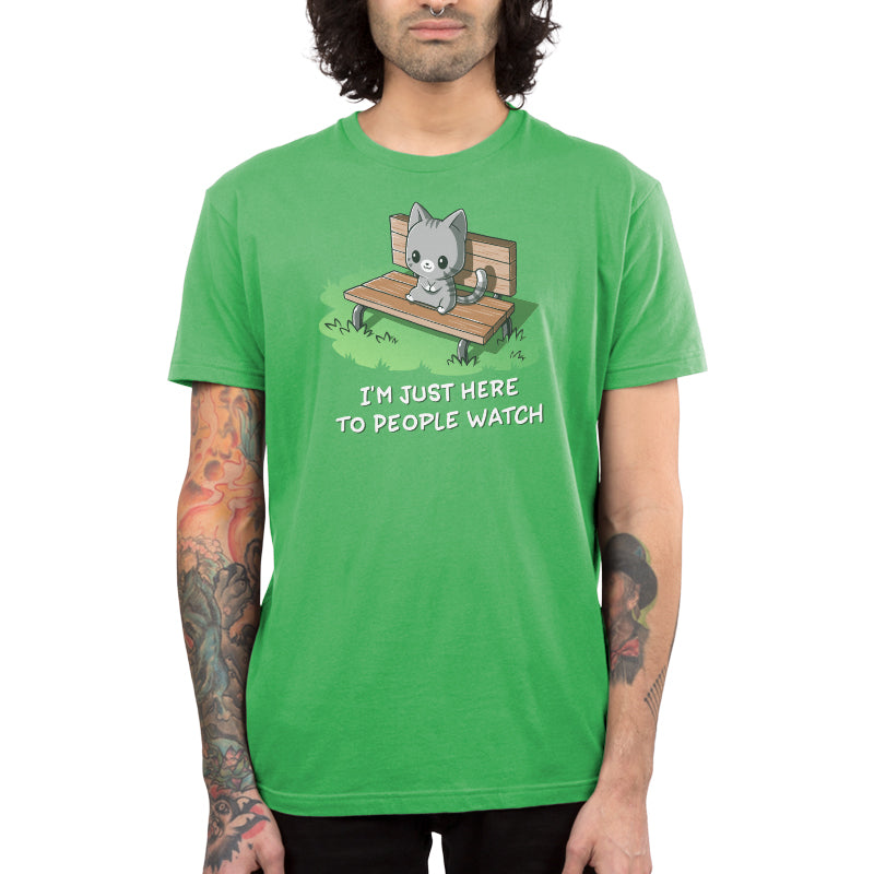 Premium Cotton T-shirt_TeeTurtle I'm Just Here to People Watch apple green t-shirt featuring an illustration of a cute gray cartoon cat sitting on a bench in the grass, accompanied by the text "I'M JUST HERE TO PEOPLE WATCH" written below. 