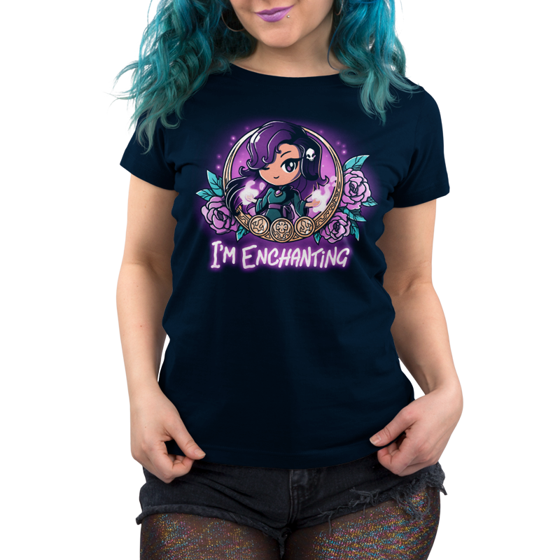 Premium Cotton T-shirt_TeeTurtle I'm Enchanting navy blue t-shirt featuring an illustration of a girl positioned within a gold-edged, ornate frame decorated with purple flowers and leaves winking her purple eyes with a white skull in her purple hair. "I'M ENCHANTING" is written underneath.