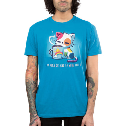 Premium Cotton T-shirt_TeeTurtle I'm Very Gay And Very Tired Cobalt Blue t-shirt featuring a cartoon cat with colorful patches holds a steaming cup featuring a rainbow and the sun. Text below reads, "I'm Very Gay and Very Tired" 