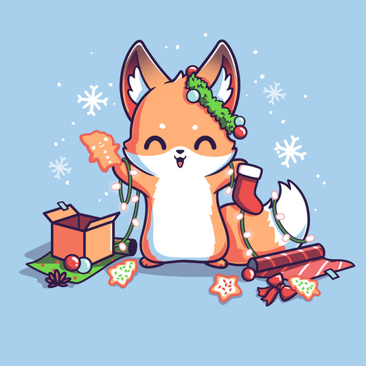 Premium Cotton T-shirt_TeeTurtle It's That Time of Year light blue t-shirt featuring a cheerful fox with green garland around its left ear surrounded by snowflakes and holding a red holiday stocking in one hand a Christmas cookie and a string of lights in the other. On the floor is red gift wrap, a red bow, Christmas cookies and a brown box on top of green gift wrap. 