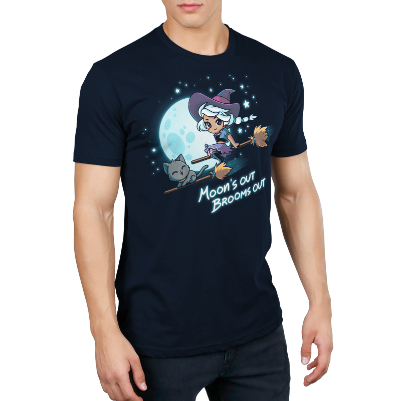 Premium Cotton T-shirt_TeeTurtle Moon's Out Brooms Out navy blue t-shirt featuring an illustration of a witch with light-gray hair, wearing a purple and dark-purple outfit and a dark purple witch's hat and a cartoon gray cat flying on two broom sticks past a full moon and starry sky. "Moon's OUT BROOMS OUT" is written underneath. 