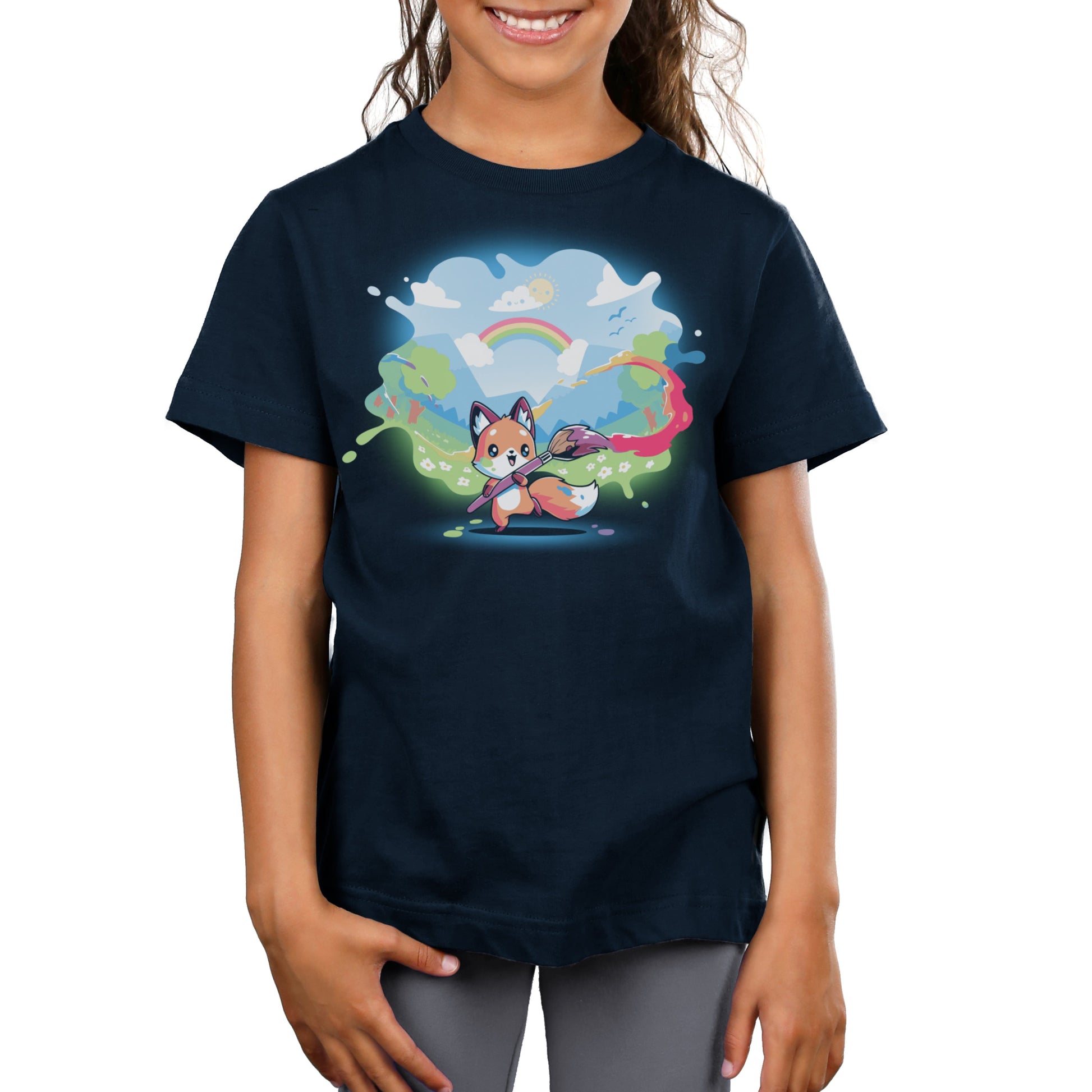 Premium Cotton T-shirt_TeeTurtle Paint Your Own World navy blue t-shirt featuring a drawing cartoon fox who holds a paintbrush, trailing vibrant colors as it paints a lively landscape with hills, trees, a rainbow, and a bright sky 