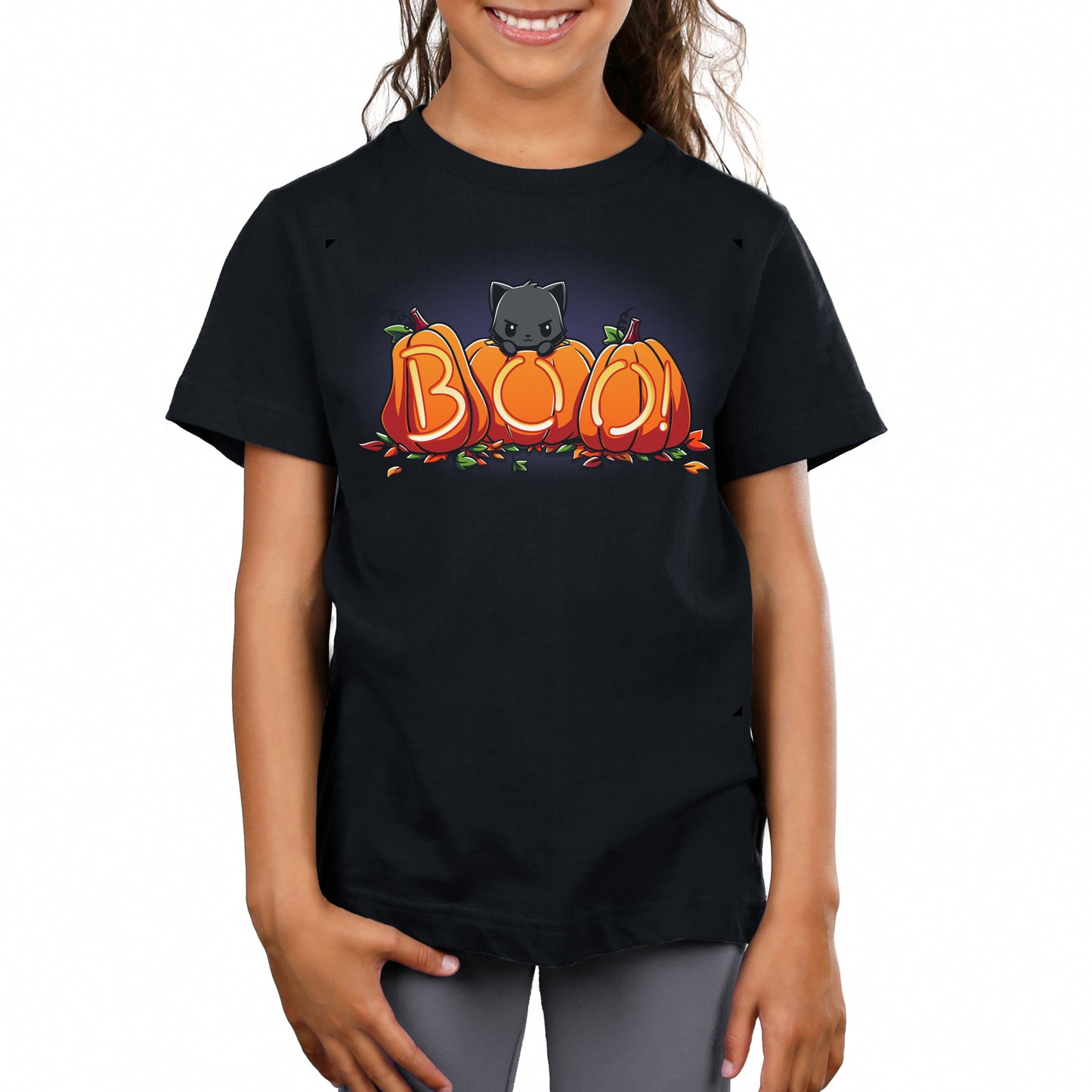 Premium Cotton T-shirt_TeeTurtle Pumpkin Kitty black t-shirt featuring a spooky black cat sitting behind three pumpkins that spell "BOO!" with glowing letters, surrounded by scattered leaves in Halloween fall colors. 