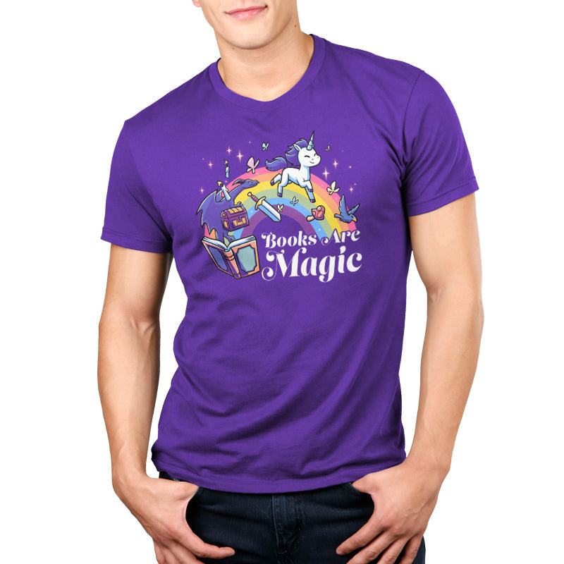 Premium Cotton T-shirt_TeeTurtle Books Are Magic(Unicorn) purple t-shirt featuring a flying unicorn, open book, rainbow, treasure chest, sword, and birds.