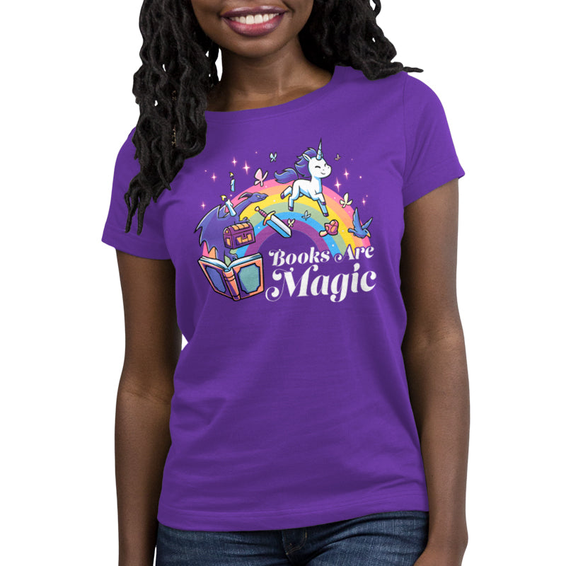 Premium Cotton T-shirt_TeeTurtle Books Are Magic(Unicorn) purple t-shirt featuring a flying unicorn, open book, rainbow, treasure chest, sword, and birds.