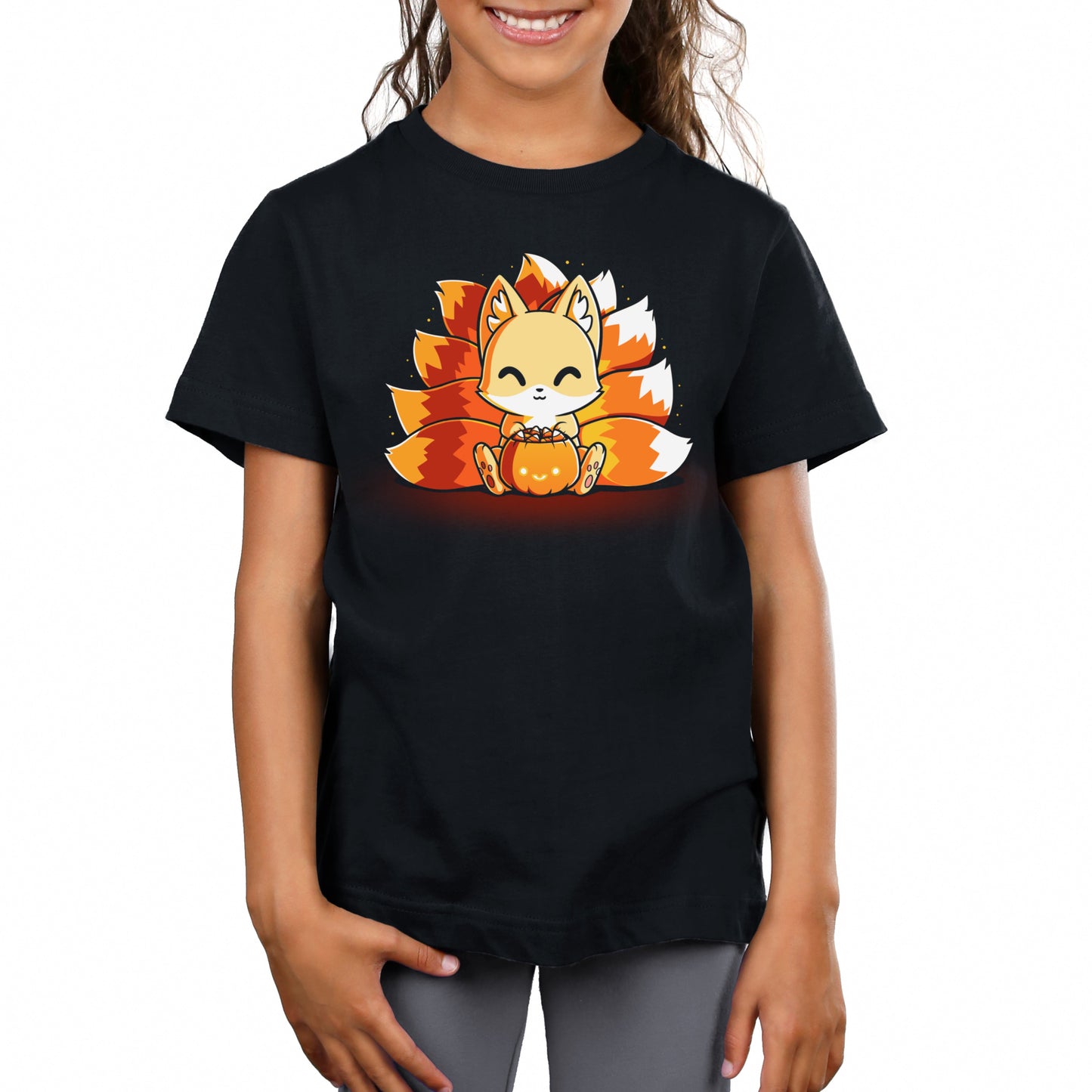 Premium Cotton T-shirt_TeeTurtle Candy Corn Kitsune black t-shirt featuring a happy kitsune holding a Halloween jack-o-lantern full of candy corn.