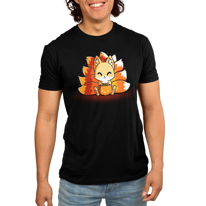 Premium Cotton T-shirt_TeeTurtle Candy Corn Kitsune black t-shirt featuring a happy kitsune holding a Halloween jack-o-lantern full of candy corn.