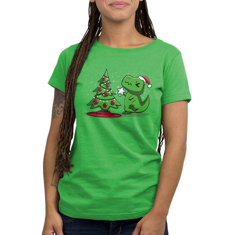 Premium Cotton T-shirt_TeeTurtle Christmas T-Rex apple green t-shirt featuring a cartoon dinosaur wearing a Santa hat placing a star atop a Christmas tree adorned with red baubles and lights. 