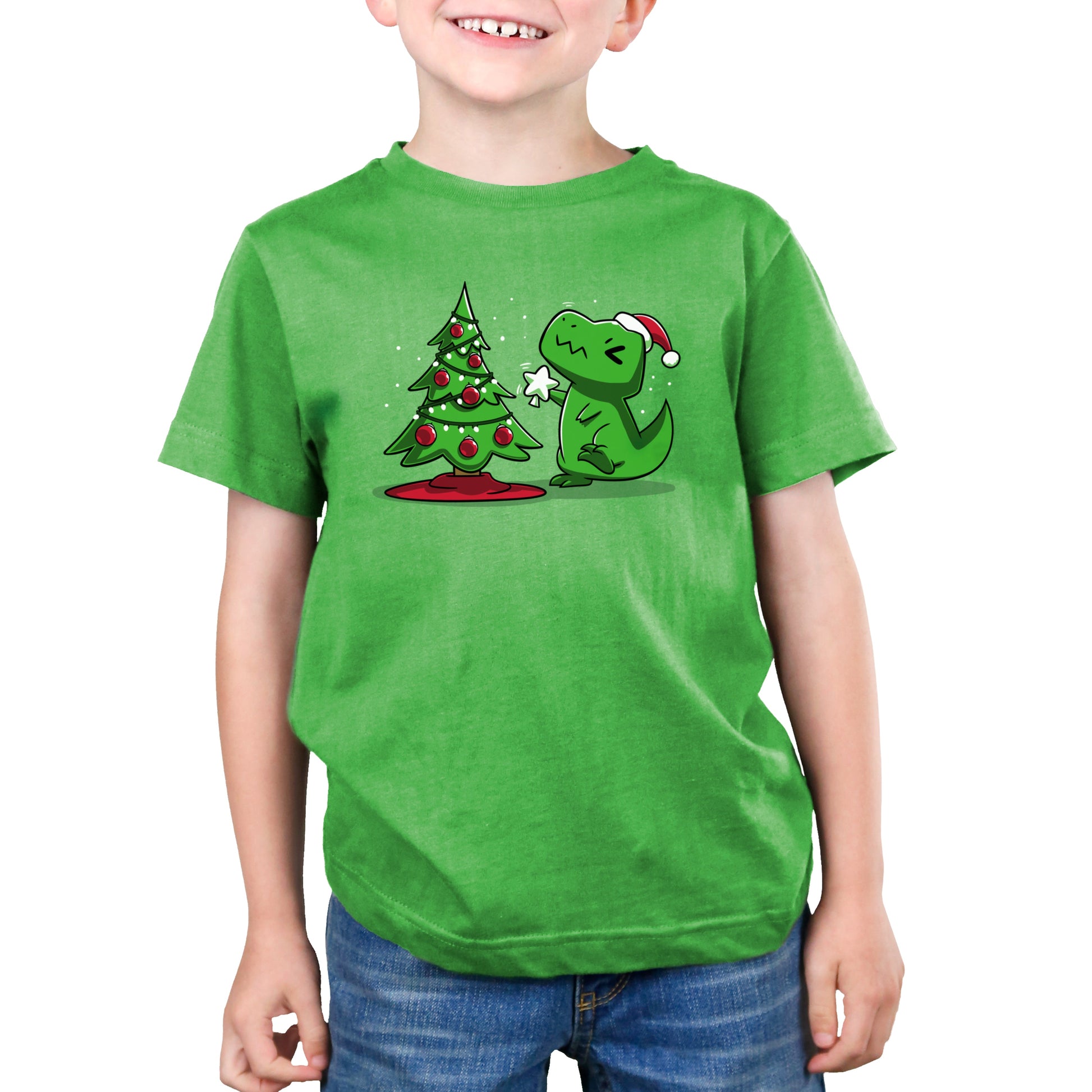 Premium Cotton T-shirt_TeeTurtle Christmas T-Rex apple green t-shirt featuring a cartoon dinosaur wearing a Santa hat placing a star atop a Christmas tree adorned with red baubles and lights. 