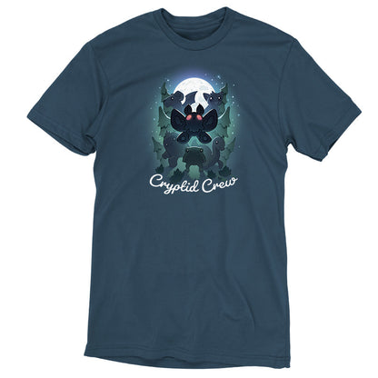 Premium Cotton T-shirt_TeeTurtle Cryptid Crew denim t-shirt featuring a whimsical illustration of six cartoon cryptids, including a mothman and a jackalope, in a forest with a full moon in the background. Text at the bottom reads "Cryptid Crew."