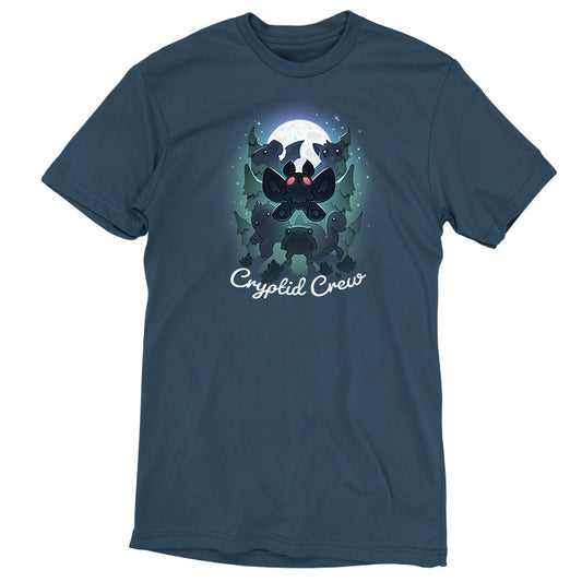 Premium Cotton T-shirt_TeeTurtle Cryptid Crew denim t-shirt featuring a whimsical illustration of six cartoon cryptids, including a mothman and a jackalope, in a forest with a full moon in the background. Text at the bottom reads 