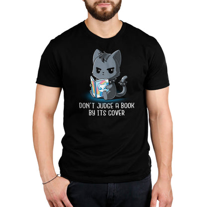 Premium Cotton T-shirt_TeeTurtle Don't Judge a Book By It's Cover black t-shirt featuring seemingly grumpy, goth-looking cat wearing a spiked collar and spiked ring on its tail reading a bright, happy-looking rainbow-covered book above the text 'Don't Judge A Book By Its Cover.'