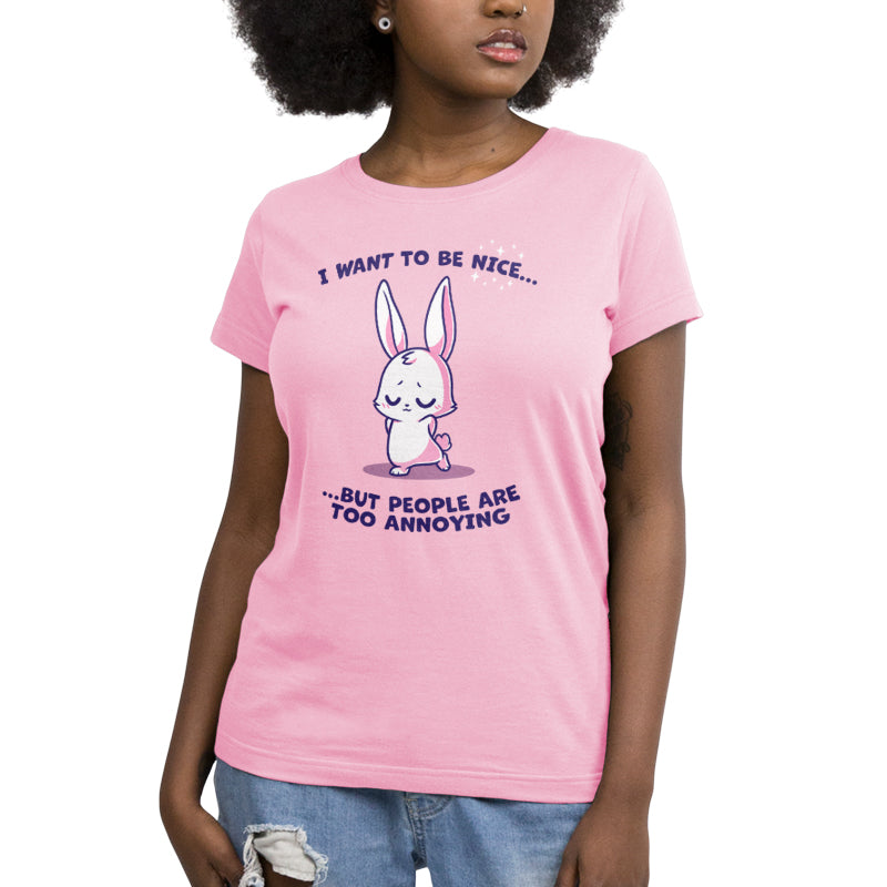 Premium Cotton T-shirt_Teeturtle I Want to Be Nice... light pink t-shirt featuring a cute bunny with closed eyes and folded ears standing with a shy expression. The text above and below says, "I want to be nice... but people are too annoying." 