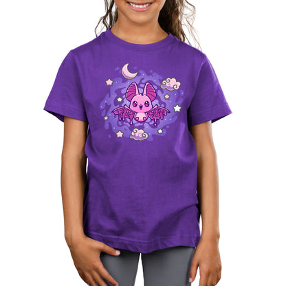 Premium Cotton T-shirt - A young child wearing a purple kids apparel featuring a pink cartoon bat with stars, clouds, and a crescent moon in the background. The apparel is called Itty Bitty Bat and is from the brand monsterdigital.