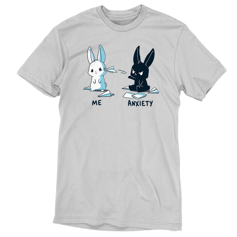 Premium Cotton T-shirt_TeeTurtle Me vs Anxiety silver gray t-shirt featuring an illustration of two cartoon bunnies. A white bunny is labeled "Me," and is looking annoyed while a paper airplane crashes into its face, while a black bunny labeled "Anxiety" aggressively throws paper planes at the other bunny. Paper planes are scattered on the ground around anxiety.