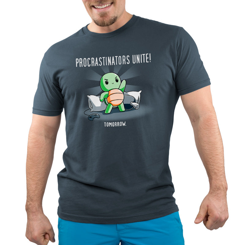 Premium Cotton T-shirt_TeeTurtle Procrastinators Unite! (Tomorrow) denim blue t-shirt featuring a green turtle standing on pillows with a game controller nearby, and text that reads, "Procrastinators Unite! Tomorrow."