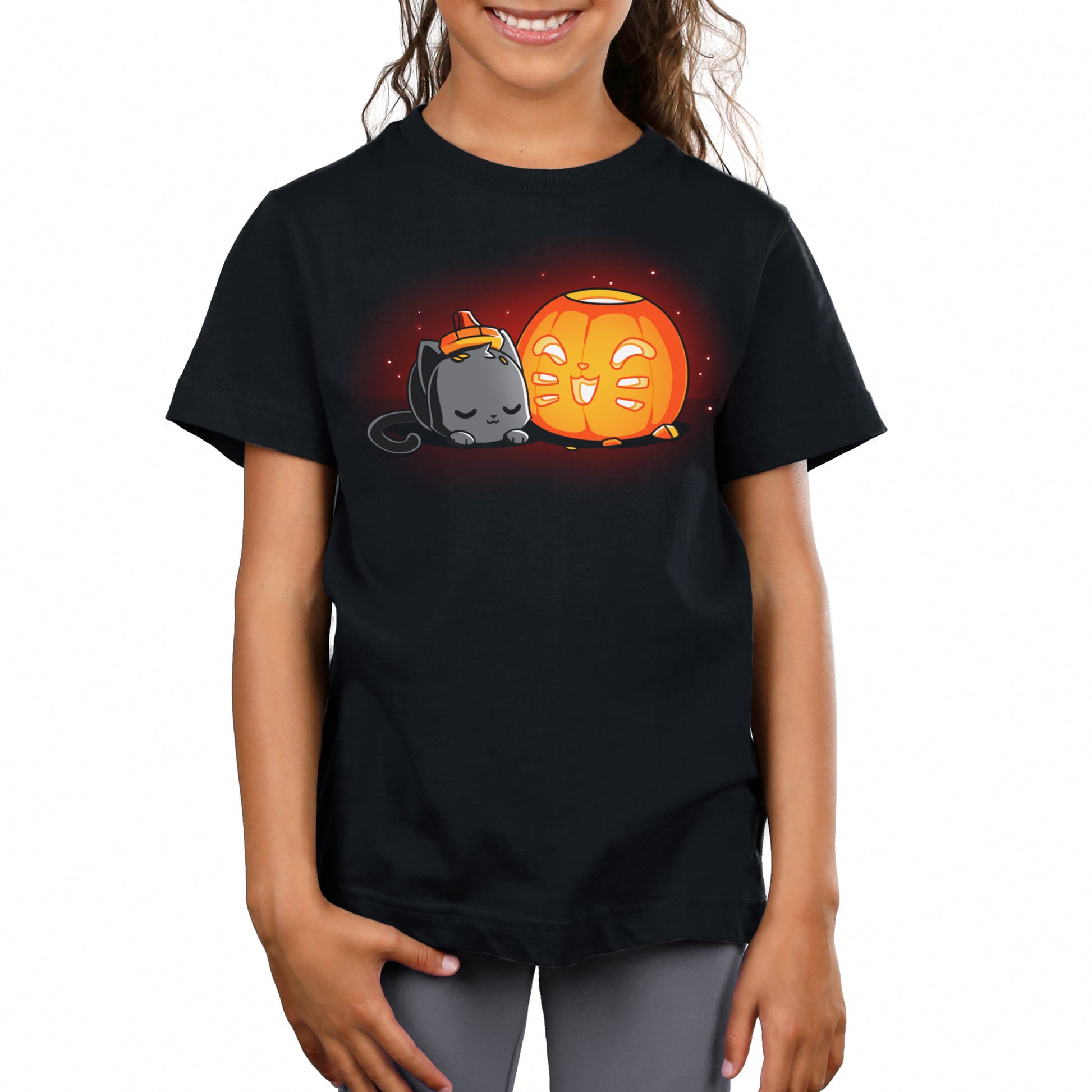 Premium Cotton T-shirt_TeeTurtle Pumpkin Carver black t-shirt featuring a cat sleeping next to a cute Halloween jack-o-lantern