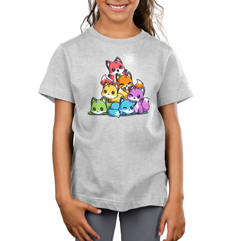 Premium Cotton T-shirt - A child wearing the Rainbow Foxes super soft ringspun cotton apparel by monsterdigital, featuring an illustration of colorful cartoon foxes stacked in a pyramid formation.