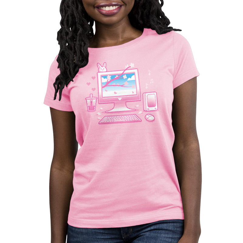 Premium Cotton T-shirt_TeeTurtle Sakura Setup pink t-shirt featuring pixel art of a desktop computer setup in pink hues. The screen displays cherry blossoms and blue sky. A bubble tea, bunny, and musical notes adorn the scene. A keyboard and mouse are positioned below.