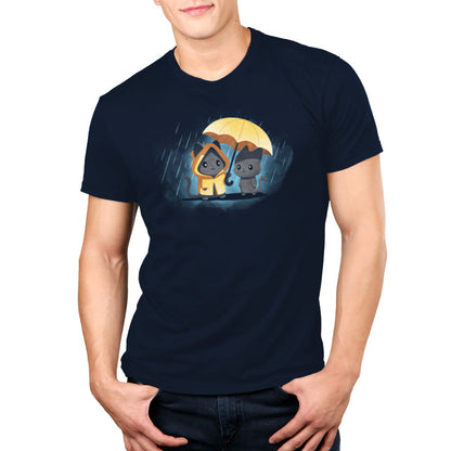 Premium Cotton T-shirt - A person wears a navy blue unisex apparelmade from 100% super soft ringspun cotton, featuring two cartoon dogs, one in a yellow raincoat, sharing a yellow umbrella in the rain. This apparelis named Sharing Kindness and is by monsterdigital.