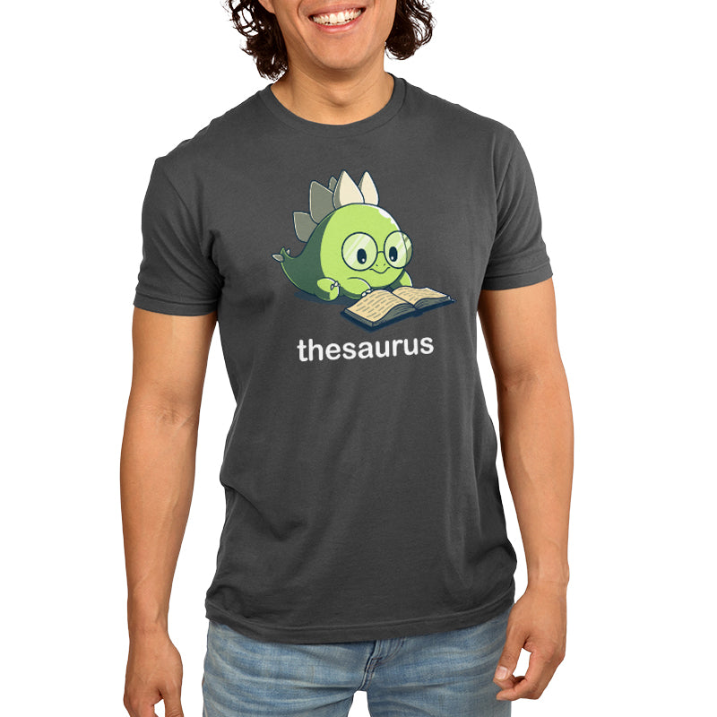 Premium Cotton T-shirt_Teeturtle Thesaurus charcoal gray t-shirt featuring a cute green dinosaur with glasses reading an open book. Below it, the word "thesaurus" is written.