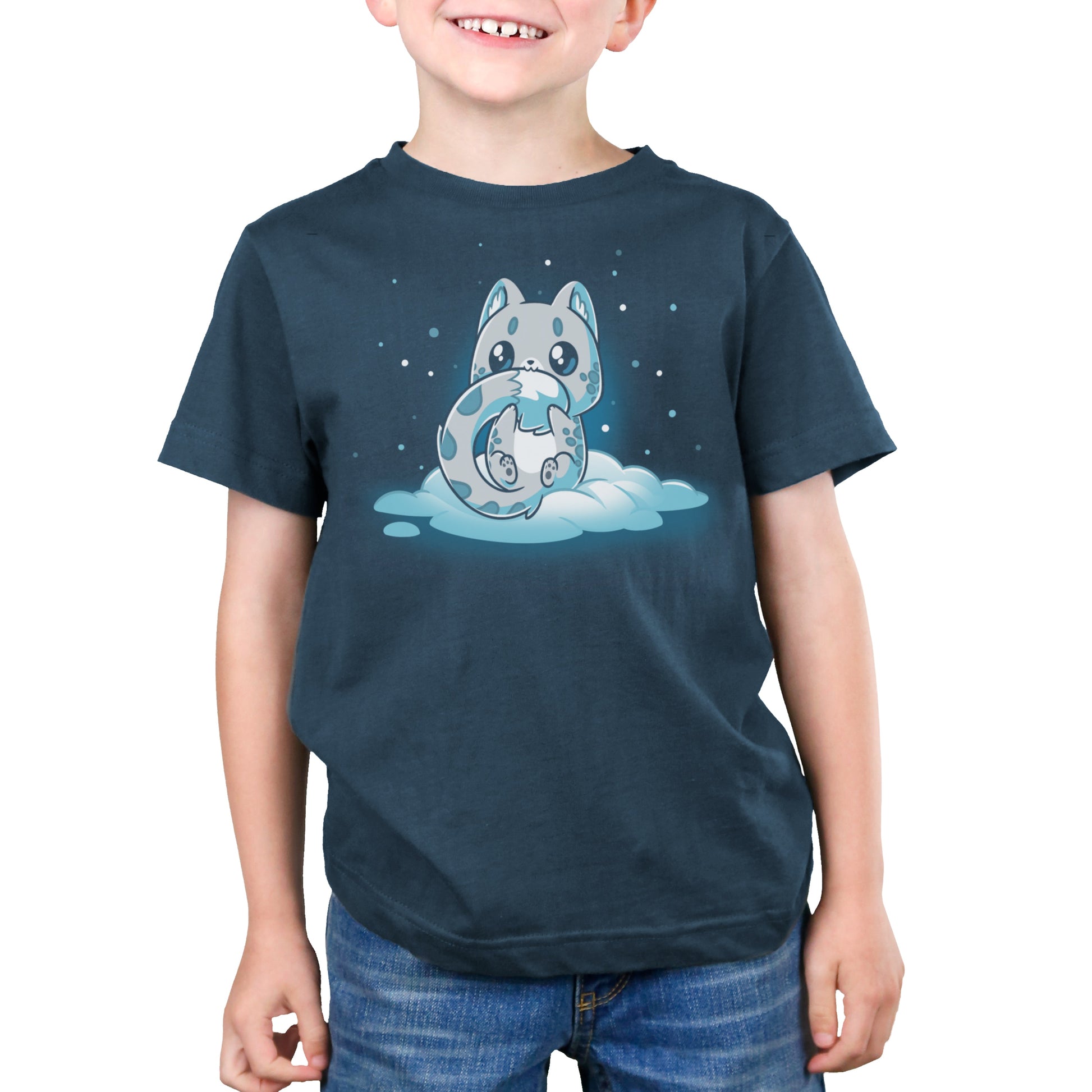 Premium Cotton T-shirt_TeeTurtle Snuggly Snow Leopard Denim t-shirt featuring a cartoon-style baby snow leopard with large eyes sitting on a cloud, hugging its tail, against a dark background with falling snowflakes. 