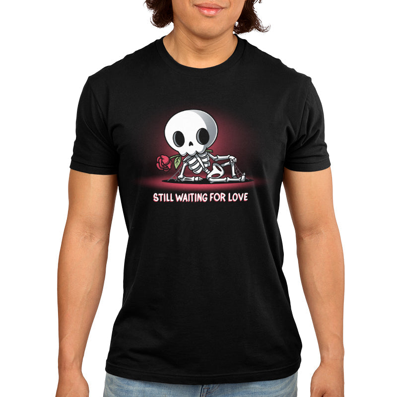 Premium Cotton T-shirt_TeeTurtle Still Waiting For Love black t-shirt featuring a skeleton holding a red rose and lying on the ground with the text "Still Waiting for Love."