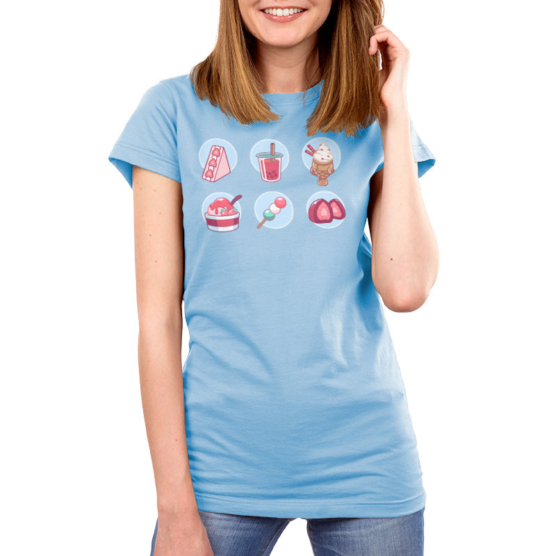 Premium Cotton T-shirt_ Sweet Treats light blue t-shirt featuring an illustration of various sweets, such as  a triangular strawberry cheesecake, pink boba drink, strawberry ice cream, a vanilla milkshake, a small stick of pink, white and green mochi balls, and a strawberry candy.