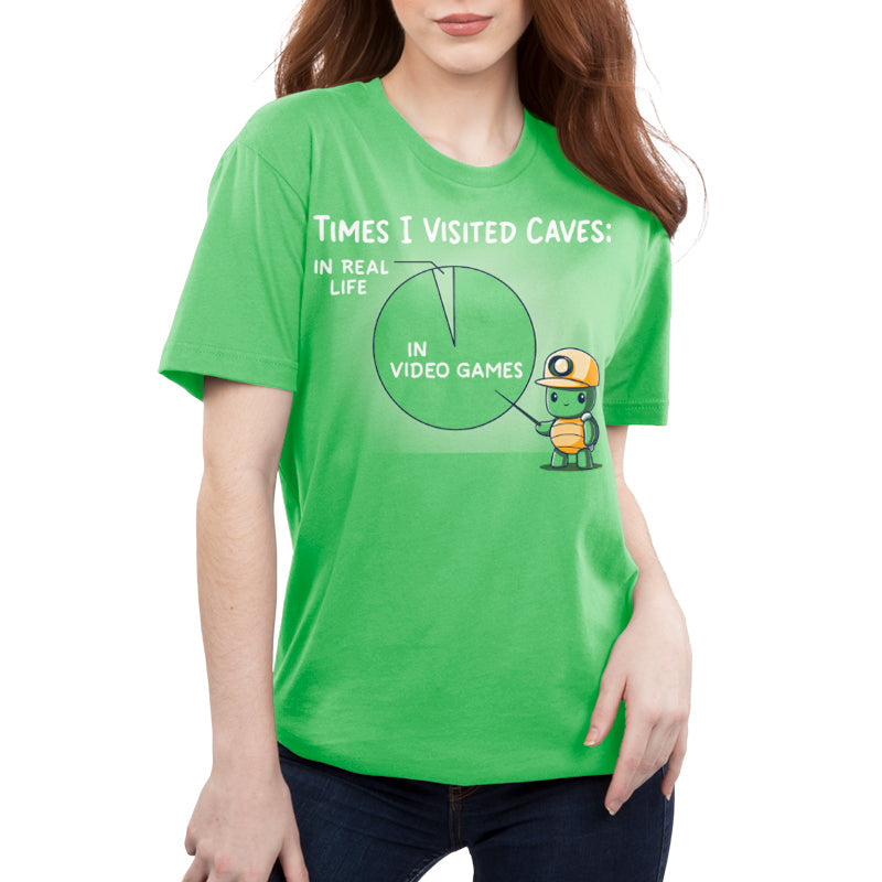 Premium Cotton T-shirt_Teeturtle Times I Visited Caves apple green t-shirt featuring a cute turtle in a miner's helmet pointing to a pie chart reading 'Times I Visited Caves' with 'In Real Life' as a small part of the chart and 'In Video Games' as the much larger part of the chart.