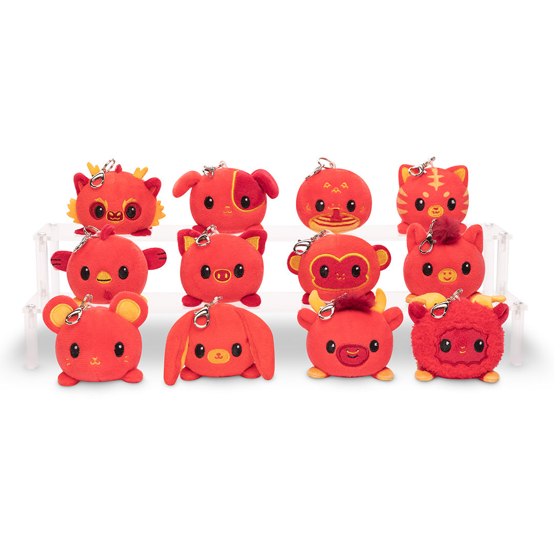 A group of red TeeTurtle Lunar New Year Snake Plushie Charm Keychain teddy bears on a white background.