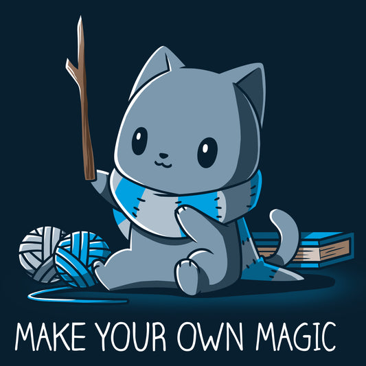 Premium Cotton T-shirt_Teeturtle Make Your Own Magic Navy Blue Featuring a gray cat sitting in front of a book next to yarn with a wand-like stick and a crafted scarf with the text 'Make Your Own Magic' below.