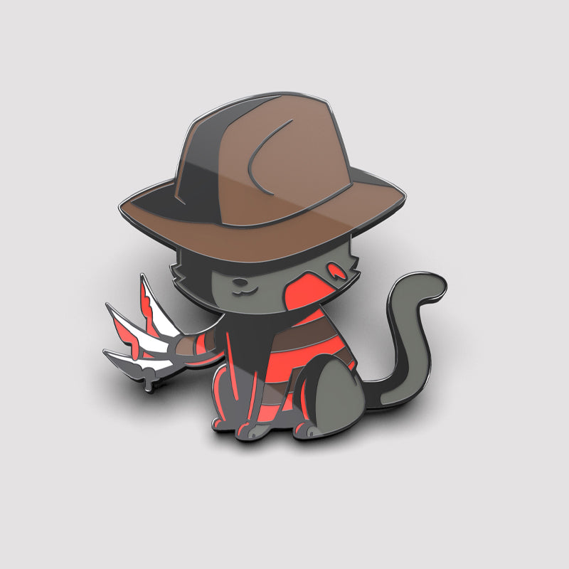 A little Nightmare Cat Pin wearing a TeeTurtle enamel pin hat.