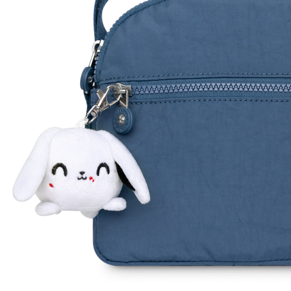 A portable blue purse with a Killer Bunny Plushie Charm Keychain by TeeTurtle attached.