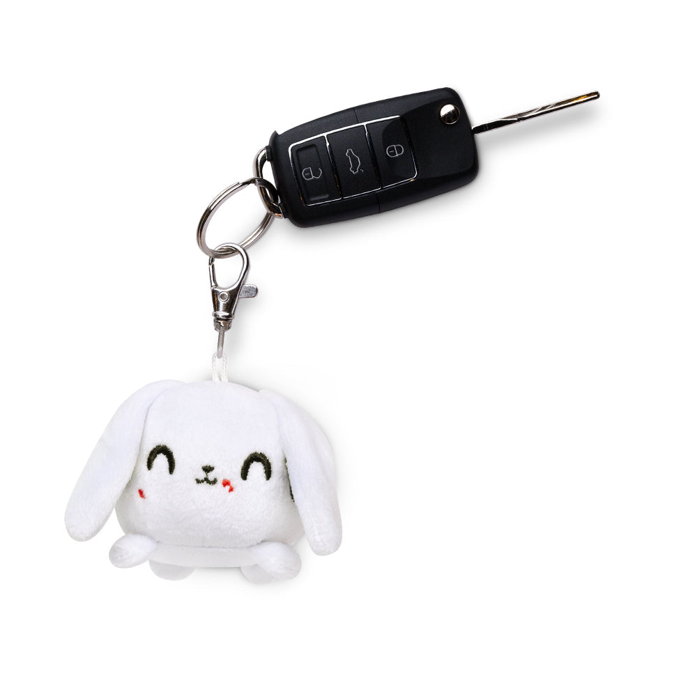 A portable TeeTurtle Killer Bunny Plushie Charm Keychain with a car key attached to it.