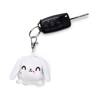 A portable TeeTurtle Killer Bunny Plushie Charm Keychain with a car key attached to it.