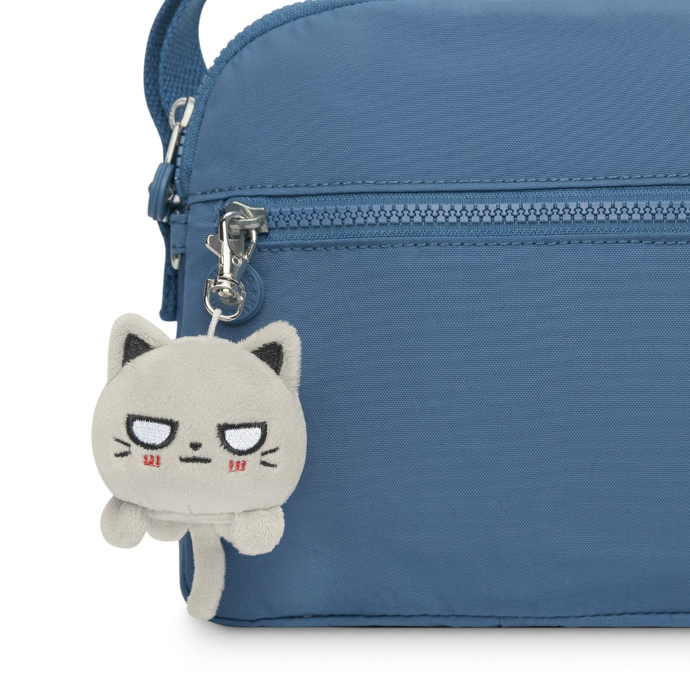 A portable bag with a TeeTurtle Cat Plushie Charm Keychain.