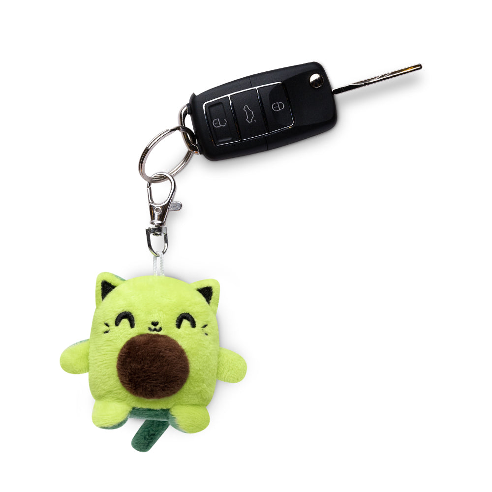 A Cat Plushie Charm Keychain by TeeTurtle is attached to a car key.