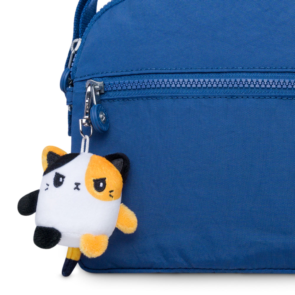 A portable blue purse with a TeeTurtle Cat Plushie Charm Keychain hanging from it.