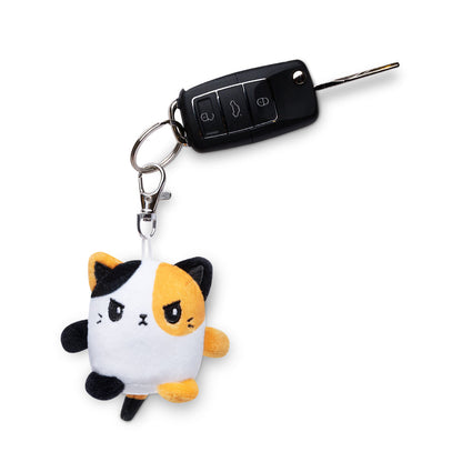 A portable Cat Plushie Charm Keychain featuring a non-reversible cat plushie by TeeTurtle.