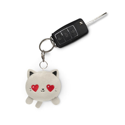 A portable Cat Plushie Charm Keychain from TeeTurtle with hearts on it.