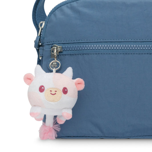 A portable purse with a Cow Plushie Charm Keychain attached to it by TeeTurtle.