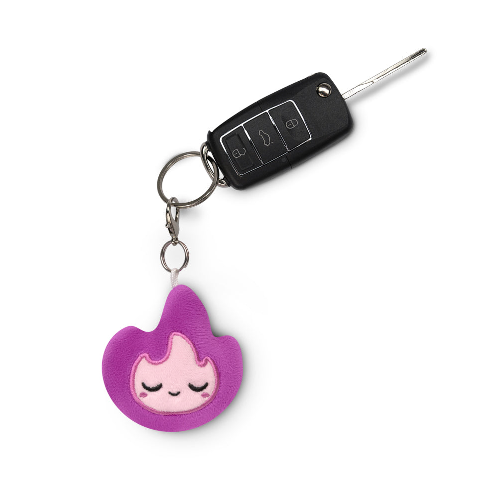 A TeeTurtle Flame Plushie Charm Keychain with a TeeTurtle pink flamingo on it.