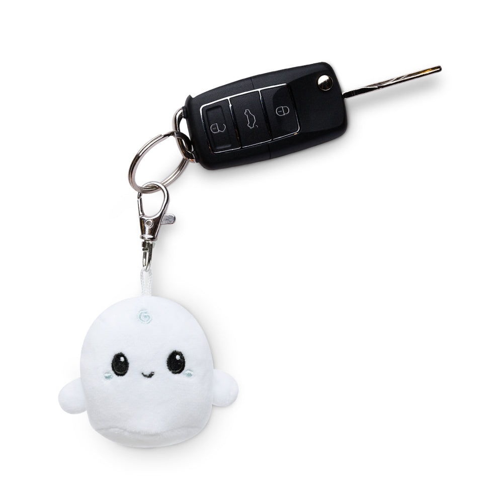 A TeeTurtle Ghost Plushie Charm Keychain is attached to a portable car key.