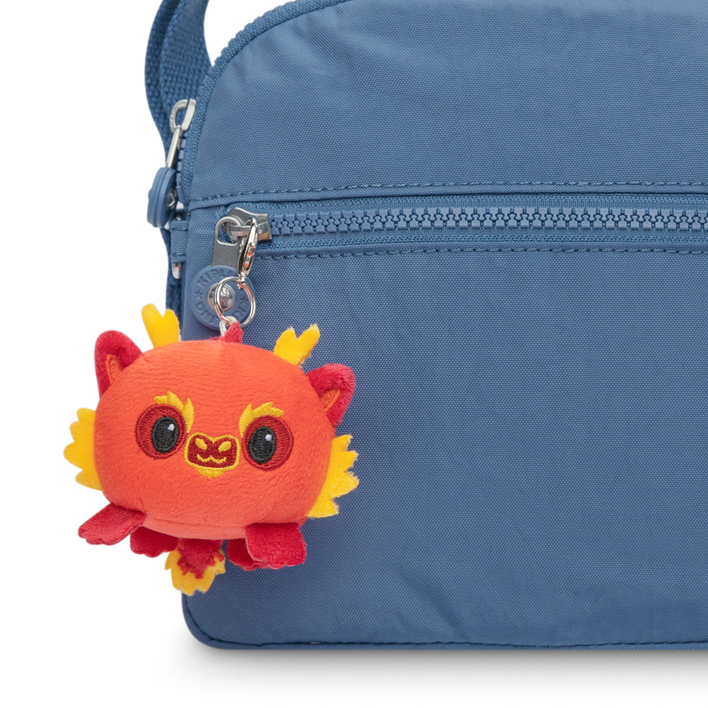 A portable Lunar New Year Dragon Plushie Charm Keychain from the TeeTurtle collection featuring a blue bag with a red and yellow stuffed animal plushie charm.