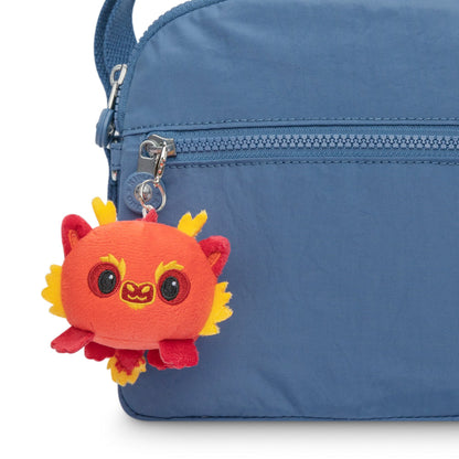 A portable bag with a blue Lunar New Year Dragon Plushie Charm Keychain representing the TeeTurtle Lunar New Year celebration.