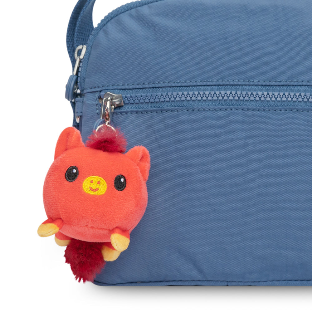 A Lunar New Year-themed backpack with a Lunar New Year Horse Plushie Charm Keychain attached by TeeTurtle.