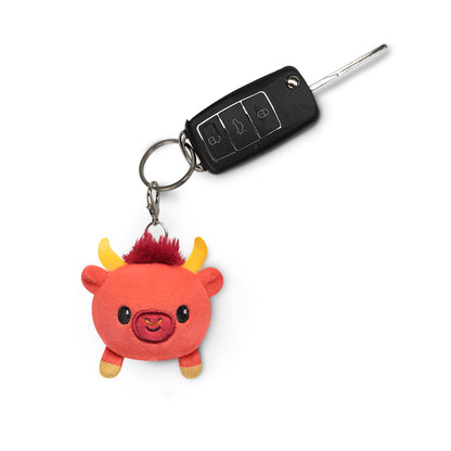 A Lunar New Year Ox plushie charm keychain featuring horns by TeeTurtle.