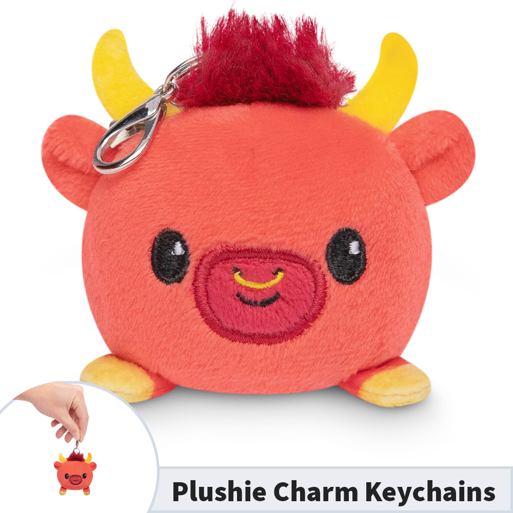 A Lunar New Year Ox Plushie Charm Keychain from TeeTurtle, with a red horn on it, perfect for keychains.